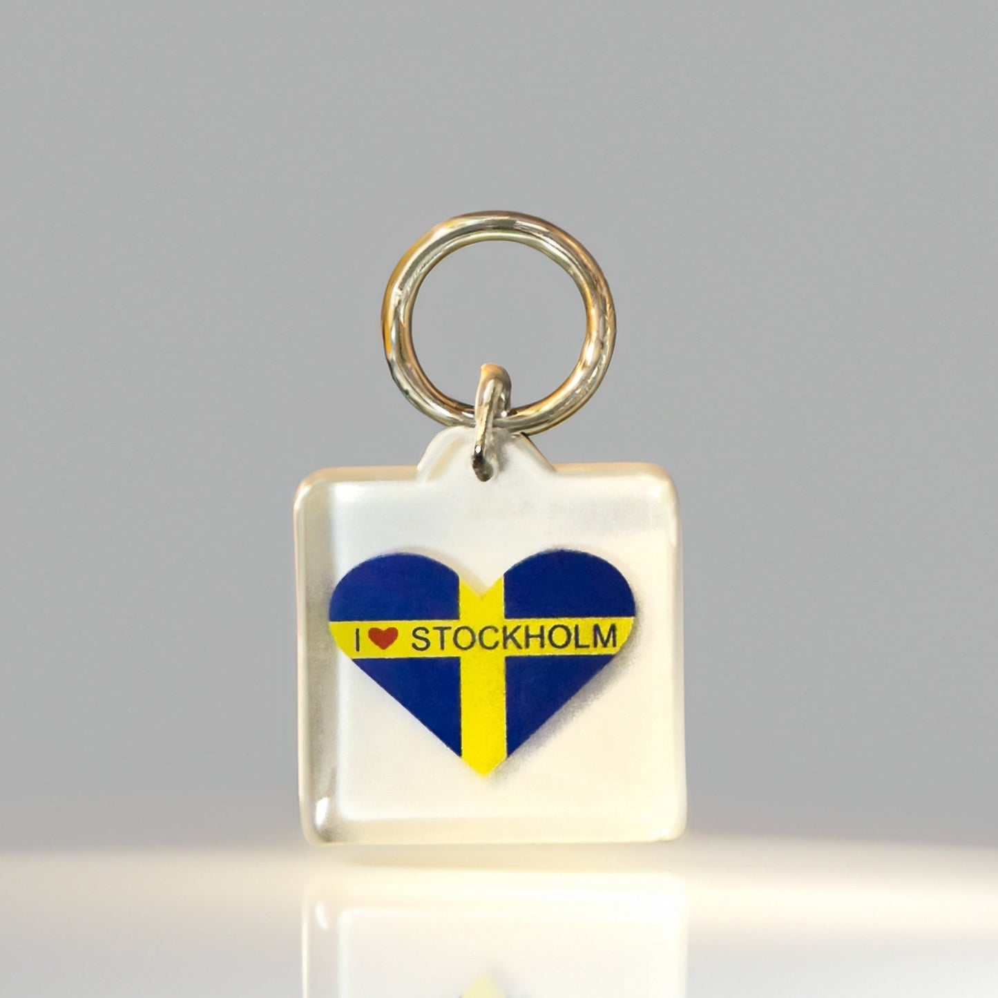 Front angle of heart-shaped I Heart Stockholm keyring with Swedish flag in clear acrylic design