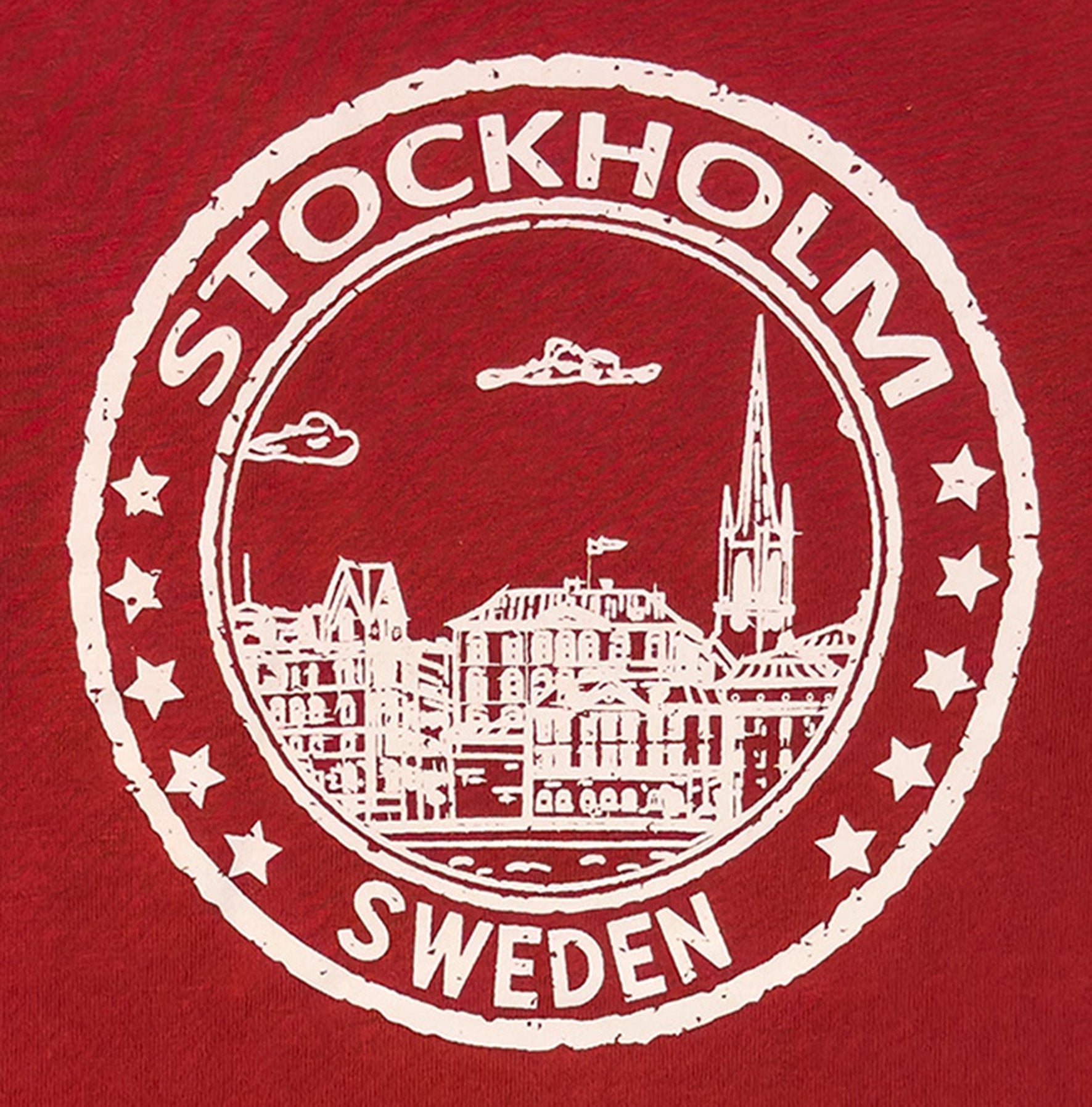 Design Details "Seal of Stockholm Children’s T-Shirt In Red Cotton featuring iconic Stockholm skyline and “Stockholm, Sweden” badge design. - Style Council