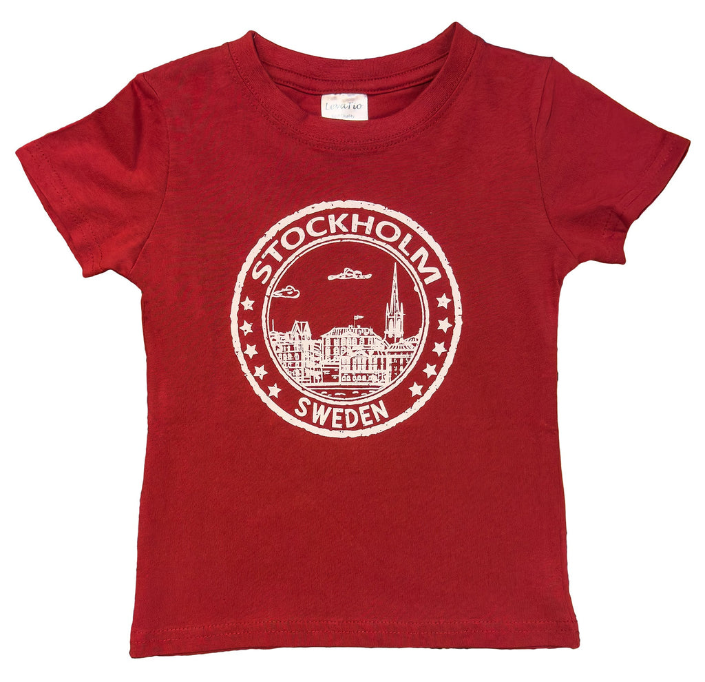 Front View of  Seal of Stockholm Children’s T-Shirt In Red Cotton featuring iconic Stockholm skyline and “Stockholm, Sweden” badge design. Sweden souvenir - Style Council