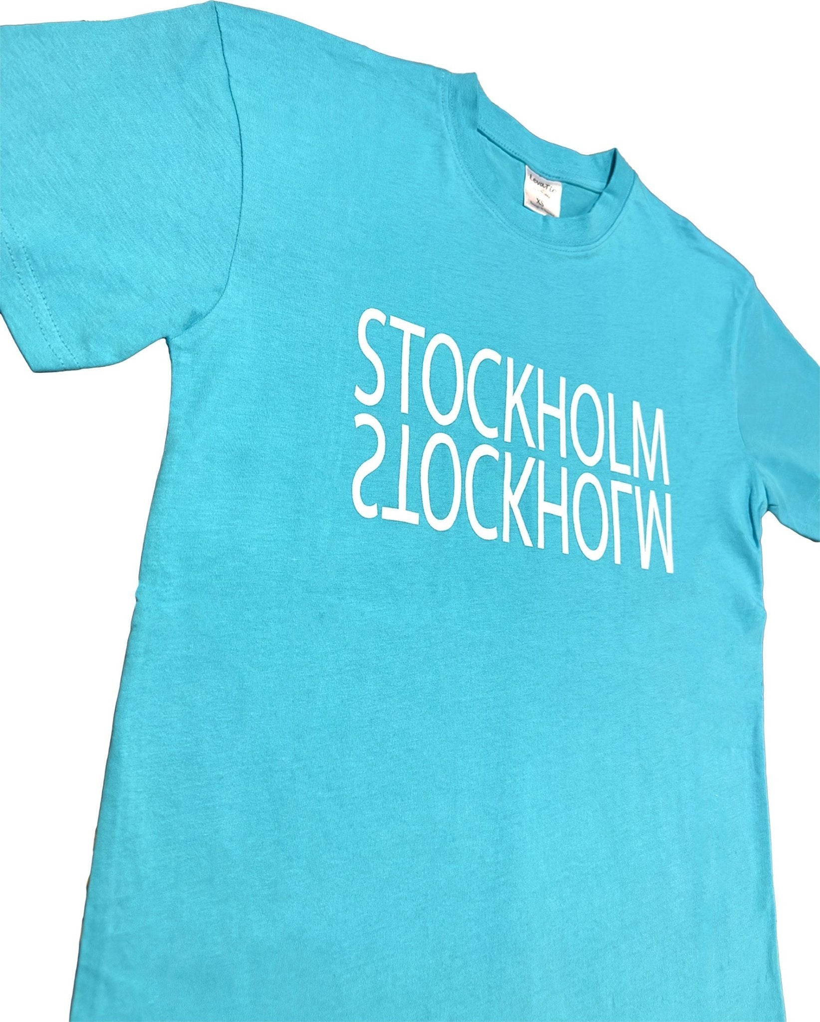 Side View of Modern turquoise Stockholm Reflection t-shirt Sky bule with mirrored “Stockholm” Text' print. - Style Council - Style Council