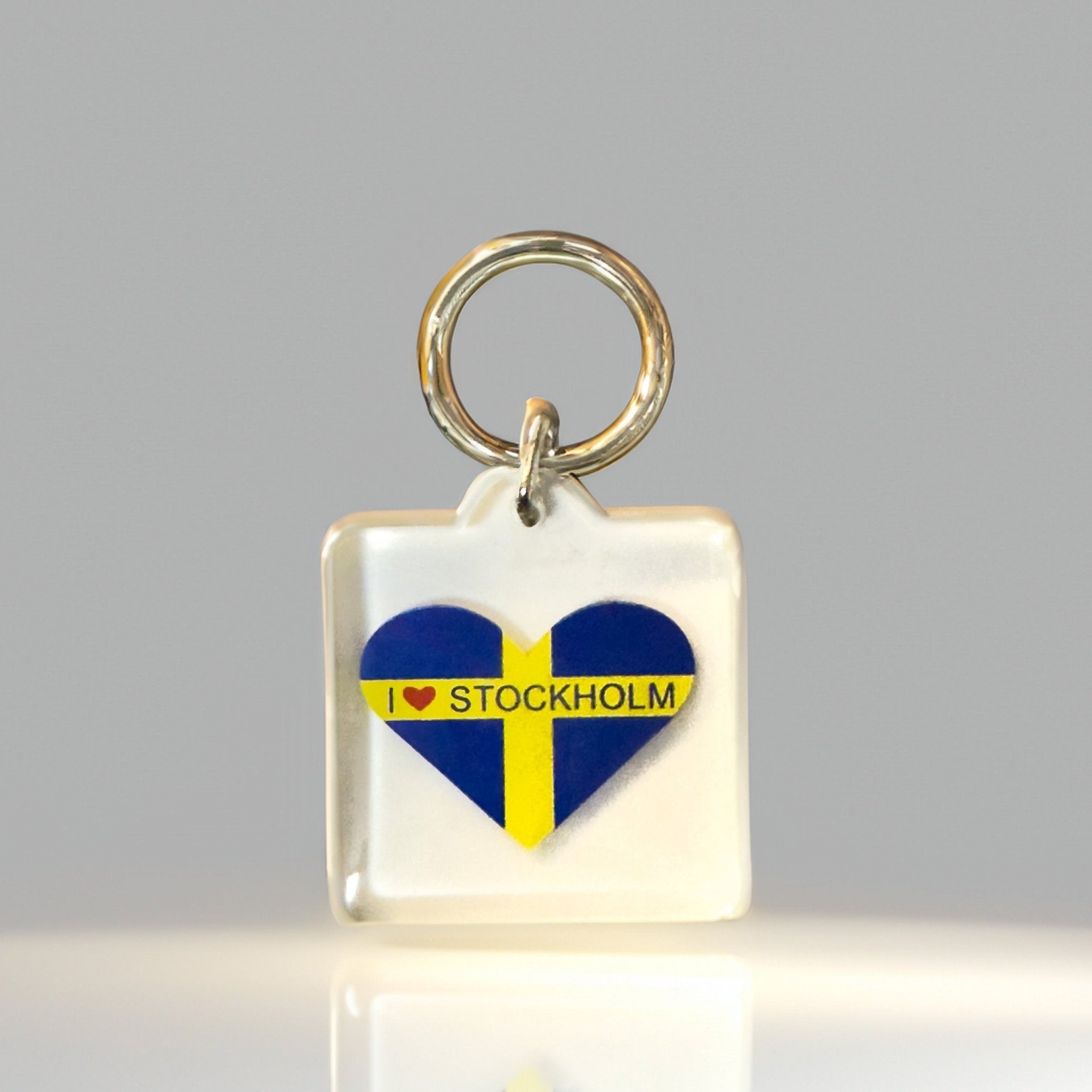 Front angle of heart-shaped I Heart Stockholm keyring with Swedish flag in clear acrylic design