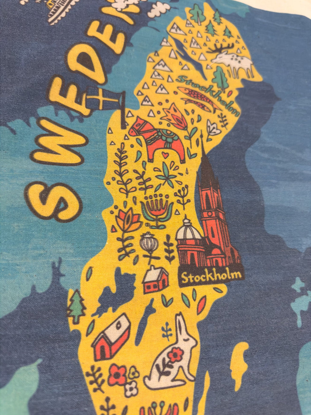Close-up of illustrated Sweden map print on canvas tote bag showing Swedish icons - Style Council